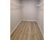 A walk-in closet featuring light gray walls and wood-look floors at 12913 Sw 82Nd Avenue Rd, Ocala, FL 34473