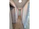 A hallway with light gray walls and wood-look floors at 12913 Sw 82Nd Avenue Rd, Ocala, FL 34473