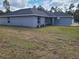 View of a well-kept single-story home, complete with freshly laid mulch and a sprawling green lawn at 12929 Sw 82Nd Avenue Rd, Ocala, FL 34473