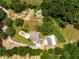 Aerial view of a wooded property with outbuildings and a house at 13045 Mountain Trail, Clermont, FL 34715