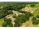 Expansive aerial view of acreage with house, garage, outbuildings, and heavily wooded areas at 13045 Mountain Trail, Clermont, FL 34715