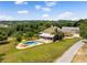 Stunning aerial view of the home, in-ground pool with a beautiful rock waterfall, and lush green landscape at 13045 Mountain Trail, Clermont, FL 34715