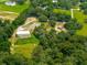 Aerial shot of a house with a large, detached garage and lush green space at 13045 Mountain Trail, Clermont, FL 34715