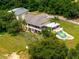 Beautiful aerial view of home with in-ground pool, screened porch, and lush landscaping at 13045 Mountain Trail, Clermont, FL 34715