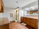 Bathroom featuring wood-look floors, shower, wooden cabinets, and plenty of counter space at 13045 Mountain Trail, Clermont, FL 34715