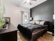 Modern bedroom featuring a black accent wall, wood-look floors, and lots of natural light at 13045 Mountain Trail, Clermont, FL 34715