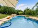 Beautiful swimming pool with a rock waterfall and lush landscaping at 13045 Mountain Trail, Clermont, FL 34715