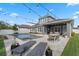 An eye-level view of the backyard with a pool, sun loungers, dining table, and covered patio with outdoor television at 1324 Utah Blvd, Orlando, FL 32803