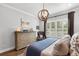 Bright bedroom featuring a dresser, side chair, and decorative lighting fixtures that create a comfortable and inviting atmosphere at 1324 Utah Blvd, Orlando, FL 32803