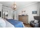 Tranquil bedroom featuring a wooden dresser, side chair, and decorative lighting fixtures that enhance the relaxing ambiance at 1324 Utah Blvd, Orlando, FL 32803