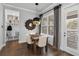 Cozy dining area features modern lighting, decor, and storage niche, bathed in natural light from the window and white door at 1324 Utah Blvd, Orlando, FL 32803