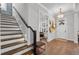 Inviting foyer with staircase, hardwood floors, and stylish lighting fixtures at 1324 Utah Blvd, Orlando, FL 32803