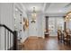 Inviting foyer with hardwood floors, modern decor, and seamless flow to the dining and living areas at 1324 Utah Blvd, Orlando, FL 32803