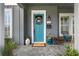 Welcoming front entrance with a blue door, stylish planters, and a modern exterior design at 1324 Utah Blvd, Orlando, FL 32803