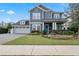 Charming two-story home with blue siding, a manicured lawn, and a welcoming front porch at 1324 Utah Blvd, Orlando, FL 32803