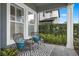 Inviting front porch with seating, modern rug, and lush greenery for a relaxing outdoor experience at 1324 Utah Blvd, Orlando, FL 32803