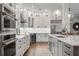 Spacious white kitchen featuring stainless appliances, center island, and sleek cabinetry at 1324 Utah Blvd, Orlando, FL 32803