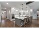 Spacious kitchen with white cabinets, an island with seating, and modern stainless steel appliances at 1324 Utah Blvd, Orlando, FL 32803