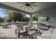 An inviting outdoor living space with a ceiling fan, outdoor television, comfortable seating, and a view of the swimming pool at 1324 Utah Blvd, Orlando, FL 32803