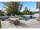 A beautiful outdoor dining area next to the pool with decorative trees and string lights in a well-manicured backyard at 1324 Utah Blvd, Orlando, FL 32803