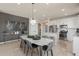 Well-lit kitchen with white cabinetry, stainless steel appliances, and a stylish dining area at 13545 Pearl Beach St, Winter Garden, FL 34787