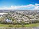 An aerial view of the community featuring multiple townhomes and a small lake at 1410 Stockton Dr, Sanford, FL 32771