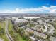 An aerial view of the community featuring multiple townhomes and a small lake at 1410 Stockton Dr, Sanford, FL 32771