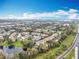 An aerial view of the community featuring multiple townhomes and a small lake at 1410 Stockton Dr, Sanford, FL 32771