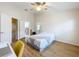 Well-lit bedroom features ceiling fan, hardwood floors, desk and ensuite bathroom at 1410 Stockton Dr, Sanford, FL 32771