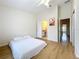 Bright bedroom featuring wood floors, a ceiling fan, a closet and a door to the bathroom at 1410 Stockton Dr, Sanford, FL 32771