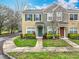 Charming townhome featuring a well-manicured lawn and colorful landscaping at 1410 Stockton Dr, Sanford, FL 32771