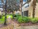 View of the exterior featuring a walkway and meticulously maintained landscaping at 1410 Stockton Dr, Sanford, FL 32771