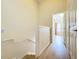 Bright upstairs hallway with hardwood floors leads to bedrooms and bathrooms at 1410 Stockton Dr, Sanford, FL 32771