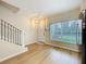 Open living area featuring stairs with metal railings, a door, and natural light at 1410 Stockton Dr, Sanford, FL 32771