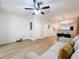 Spacious living room features ceiling fan, hardwood floors and open floor plan at 1410 Stockton Dr, Sanford, FL 32771