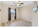 Simple bedroom with a window and wood-look floors, perfect for relaxation at 1411 Pacific Rd, Poinciana, FL 34759