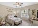 Charming bedroom with light wood floors, a ceiling fan, and serene decor at 1411 Pacific Rd, Poinciana, FL 34759