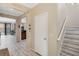 Inviting entryway with wood-look floors and staircase, leading to various living spaces at 1411 Pacific Rd, Poinciana, FL 34759