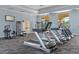 Bright gym with multiple treadmills, weight machines, neutral carpet and view to the outdoors at 1411 Pacific Rd, Poinciana, FL 34759