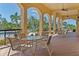 Community outdoor patio with tables, chairs, ceiling fans, and views of the pool at 1411 Pacific Rd, Poinciana, FL 34759