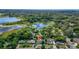 Aerial view of the property's location surrounded by lush trees, a pool, and nearby lakes at 1412 Lakecrest Dr, Apopka, FL 32703