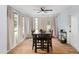 Bright open dining area features light and airy curtains, a modern ceiling fan, and a large wooden table with chairs at 1412 Lakecrest Dr, Apopka, FL 32703