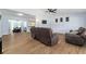 Open concept living room with light wood floors and neutral paint, flowing into a dining room and kitchen at 1412 Lakecrest Dr, Apopka, FL 32703