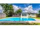 Beautiful in-ground pool with ladders, set against a backdrop of a screened-in porch and white home exterior at 1412 Lakecrest Dr, Apopka, FL 32703