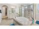 Bathroom featuring a frameless glass shower, soaking tub, and double vanity at 14504 Sunbridge Cir, Winter Garden, FL 34787