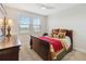 Bedroom with a large bed, ceiling fan, a side table, and a view of the outside at 14504 Sunbridge Cir, Winter Garden, FL 34787