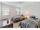 Inviting bedroom featuring twin beds, plush carpet, and natural light from the two windows at 14504 Sunbridge Cir, Winter Garden, FL 34787