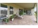 Cozy covered patio with brick pavers, seating, grill, and potted plants, perfect for relaxing outdoors at 14504 Sunbridge Cir, Winter Garden, FL 34787