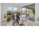 Sunlit dining area featuring a modern glass-top table, contemporary chairs, and sliding glass doors to outdoor space at 14504 Sunbridge Cir, Winter Garden, FL 34787