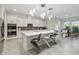 Well-lit kitchen featuring an island with bar seating, stainless steel appliances, and seamless flow to dining at 14504 Sunbridge Cir, Winter Garden, FL 34787